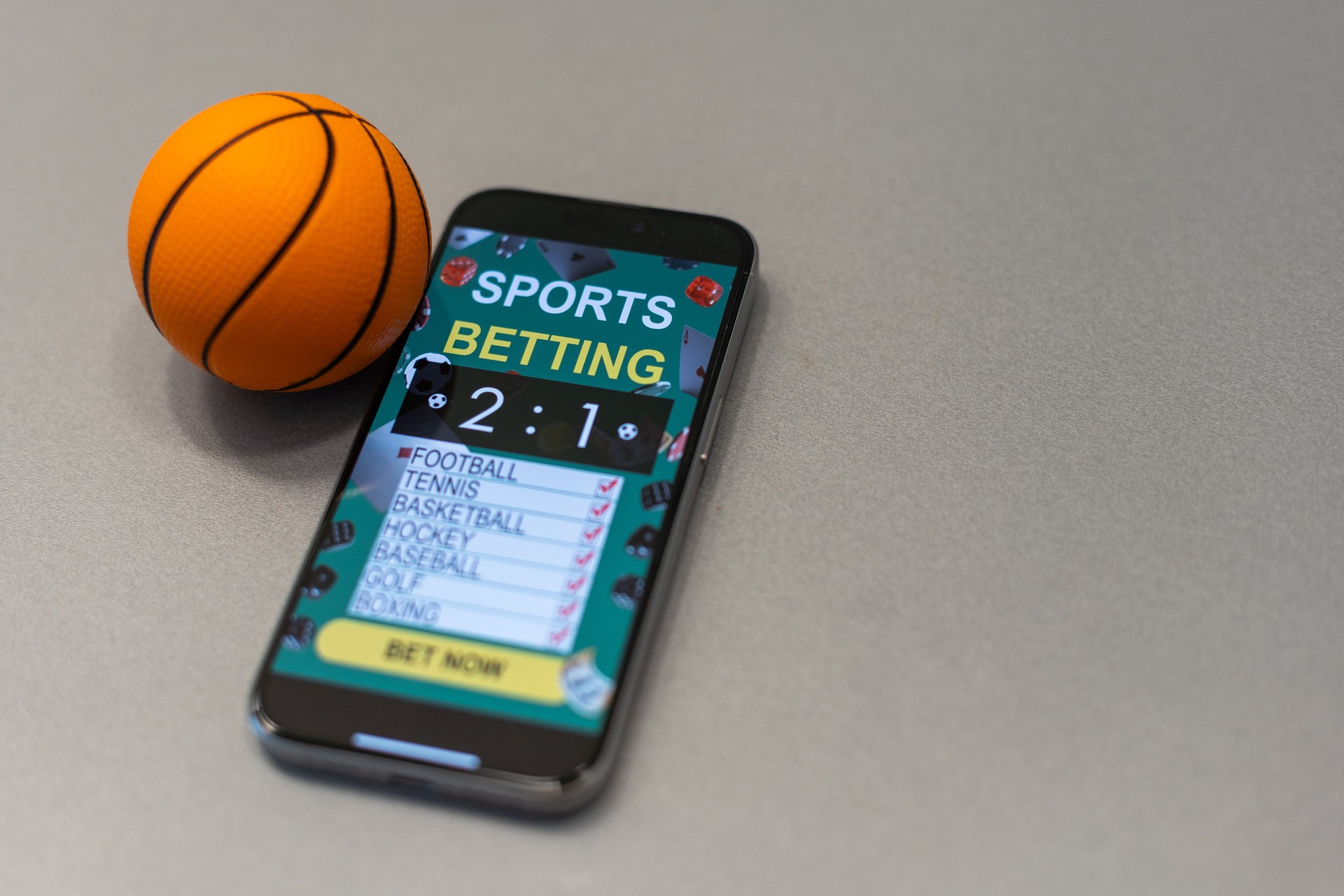 Sports betting website in a mobile phone screen, ball, money